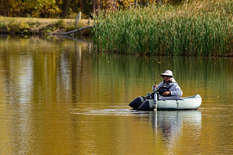 A person in a canoe in a river in St. Vrain State Park